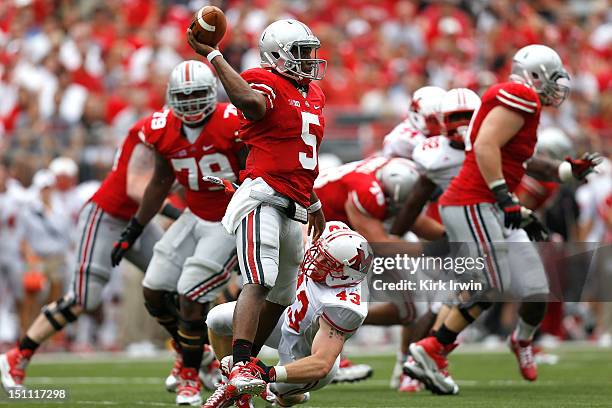 Kent Kern of the Miami Redhawks hits Braxton Miller of the Ohio State Buckeyes as he throws the ball downfield during the second quarter on September...