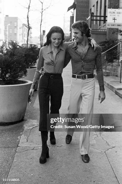 Belgian-born American fashion designer Diane von Furstenberg walks down a sidewalk with her husband, Swiss baron Egon von Furstenberg , New York, New...