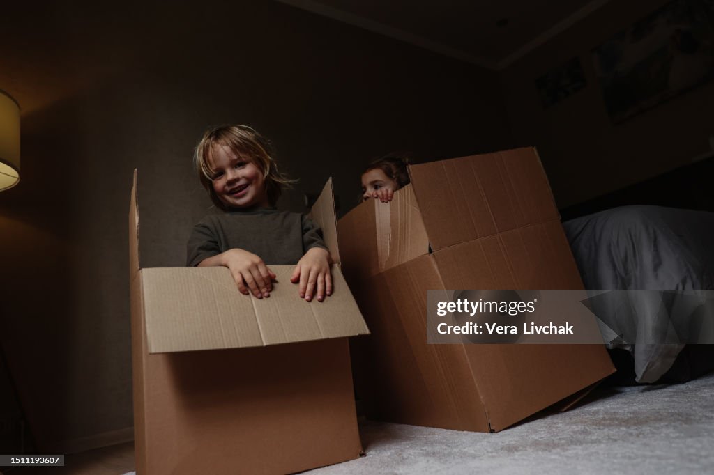 Children With Box Little Children Play With A Huge Cardboard Box And Smiling At Home High ...