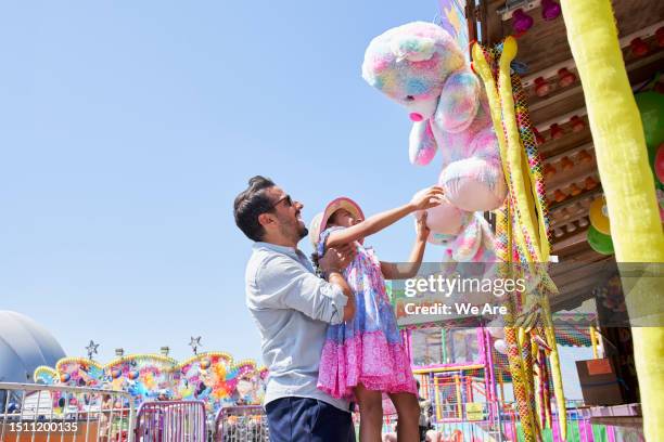 choosing a prize - child picking up toys stock pictures, royalty-free photos & images