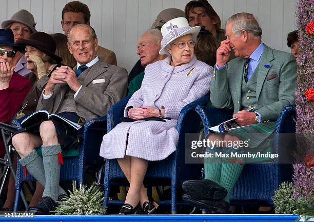 Prince Philip, Duke of Edinburgh, Queen Elizabeth II and Prince Charles, Prince of Wales attend the 2012 Braemar Highland Gathering at The Princess...