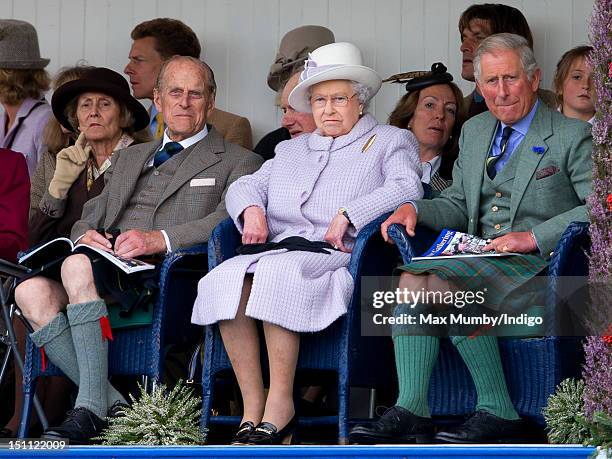 Prince Philip, Duke of Edinburgh, Queen Elizabeth II and Prince Charles, Prince of Wales attend the 2012 Braemar Highland Gathering at The Princess...