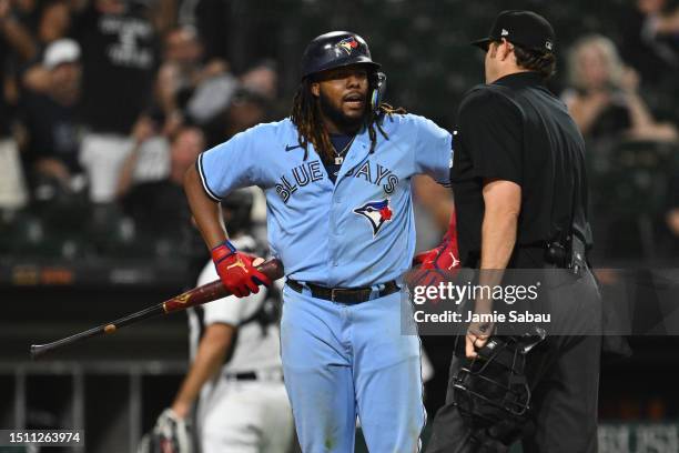 Vladimir Guerrero Jr. #27 of the Toronto Blue Jays questions a strike call with umpire Ryan Additon in the ninth inning of game two of a...