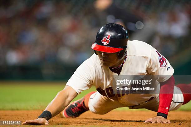 Shin-Soo Choo of the Cleveland Indians dives back to first during the seventh inning against the Texas Rangers at Progressive Field on September 1,...