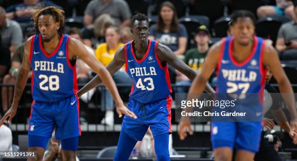 Makur Maker of the Philadelphia 76ers looks on with teammates Greg Brown III and Elijah McCadden during the second half of their NBA Summer League...