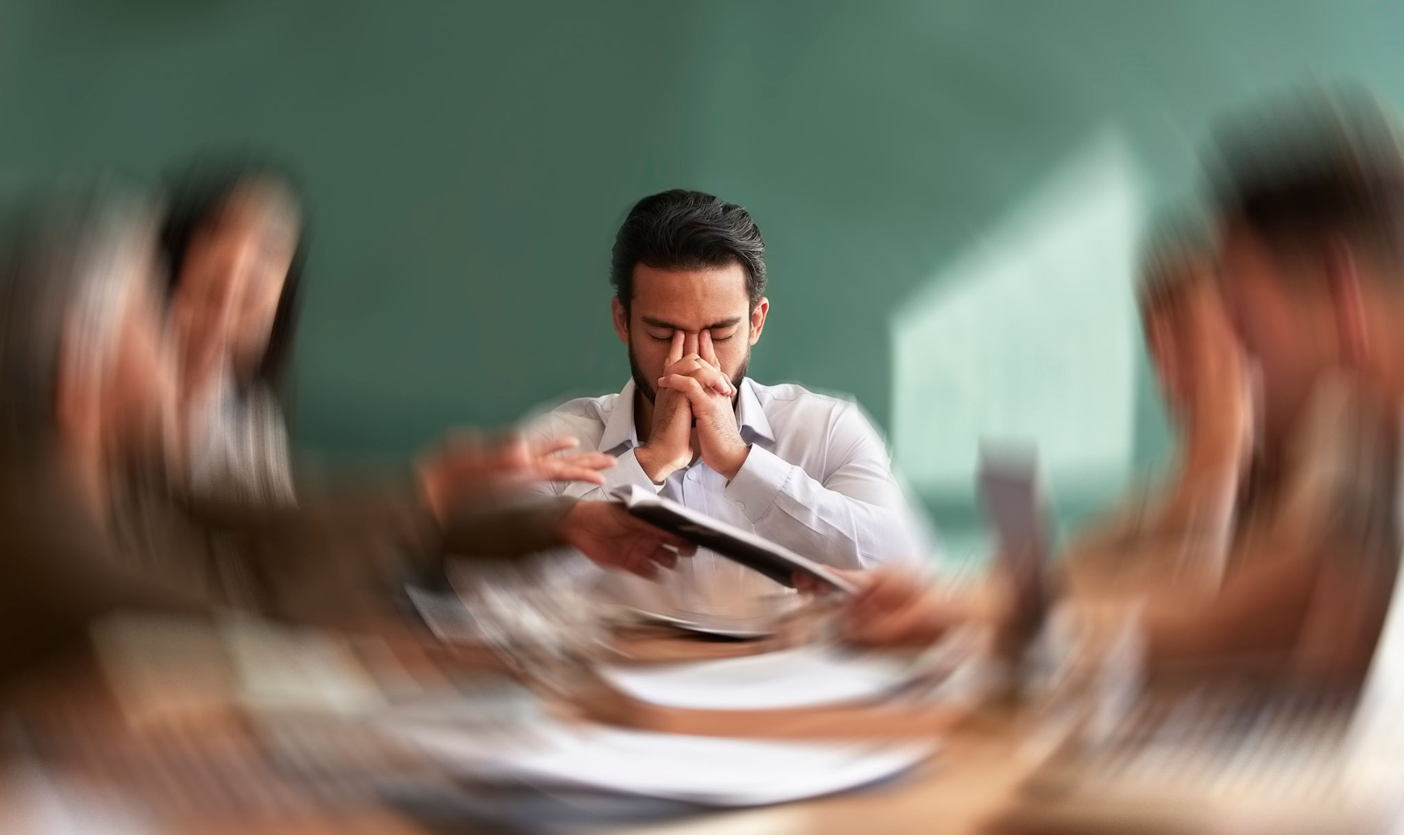 Stress, migraine and motion blur with a business man in a meeting feeling frustrated, tired or overworked. Mental health, anxiety and headache with an exhausted male employee suffering from fatigue Stress, migraine and motion blur with a business man in a meeting feeling frustrated, tired or overworked. Mental health, anxiety and headache with an exhausted male employee suffering from fatigue