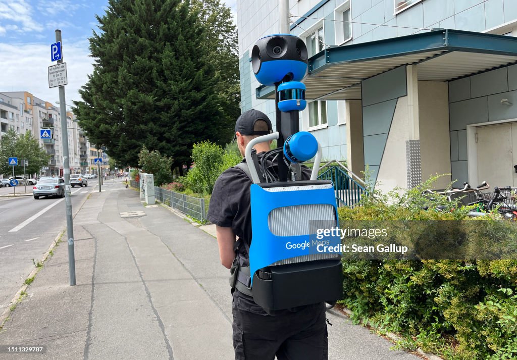 A man carrying a Google Street View Trekker backpack walks in the