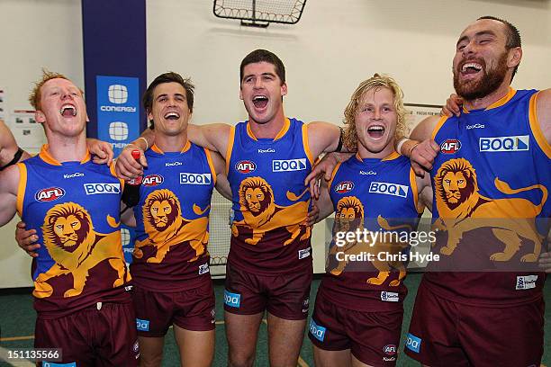 Josh Green, Jed Alcock, Jonathan Brown, Daniel Rich and Ben Hudson of the Lions sing the team song after winning the round 23 AFL match between the...