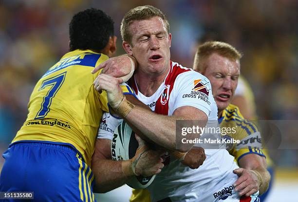 Ben Creagh of the Dragons is tackled during the round 26 NRL match between the Parramatta Eels and the St George Illawarra Dragons at ANZ Stadium on...