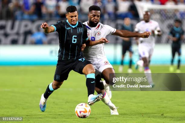 Bryan Acosta of Honduras and Duckens Nazon of Haiti battle for control of the ball during the second half of the Concacaf Gold Cup match at Bank of...