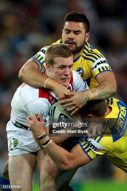 Ben Creagh of the Dragons is tackled during the round 26 NRL match between the Parramatta Eels and the St George Illawarra Dragons at ANZ Stadium on...