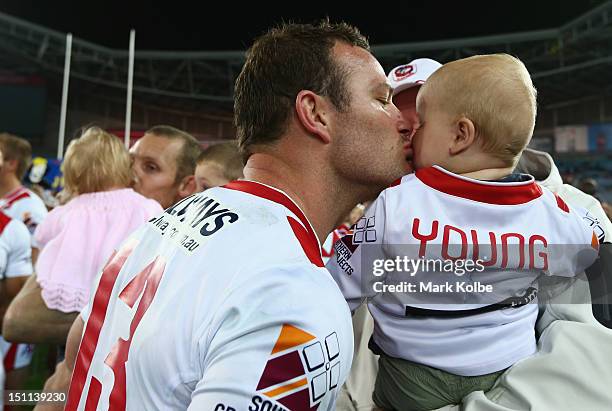 Dean Young of the Dragons kisses his baby after his final NRL match in the round 26 NRL match between the Parramatta Eels and the St George Illawarra...