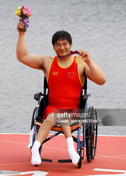 China's Cheng Huang celebrates winning the gold medal in the AS men single sculls during the London 2012 Paralympic Games in Eton Dorney on September...