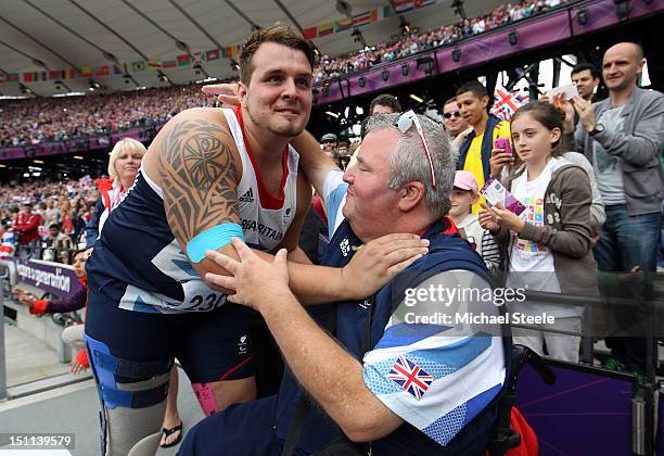 Aled Davies of Great Britain hugs his coach Anthony Hughes after he won gold in the Men's Discus Throw - F42 Final on day 4 of the London 2012...