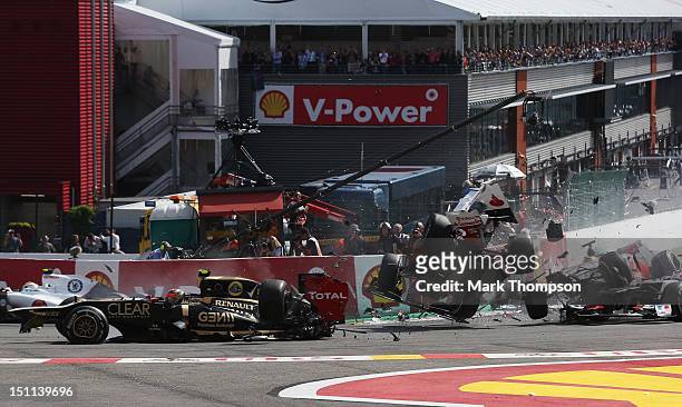 Romain Grosjean of France and Lotus, Fernando Alonso of Spain and Ferrari and Lewis Hamilton of Great Britain and McLaren collide and crash out at...