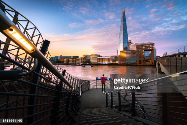 tourist travel with view of the shard tower from london bridge over thames river with beautiful sunset or sunrise view of downtown in city of london, great britain, united kingdom, uk - k'nub stock pictures, royalty-free photos & images