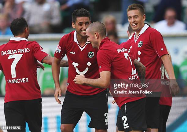 Leon Andreasen of Hannover celebrates with his team mates after scoring his team's third goal during the Bundesliga match between VfL Wolfsburg and...