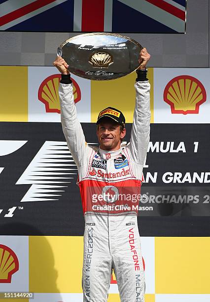 Jenson Button of Great Britain and McLaren celebrates on the podium after winning the Belgian Grand Prix at the Circuit of Spa Francorchamps on...