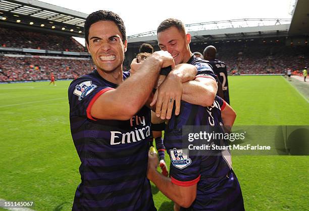 Mikel Arteta celebrates the 2nd Arsenal goal scored by Santi Cazorla during the Barclays Premier League match between Liverpool and Arsenal at...