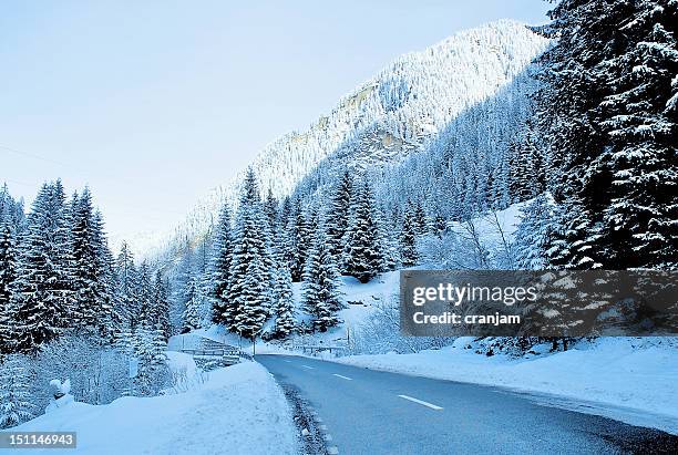 alps mountain - snow road stock-fotos und bilder