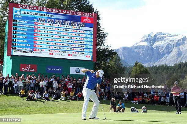 Richie Ramsay of Scotland celebrates as he holes the final putt on the 18th green to secure victory during final round of the Omega European Masters...