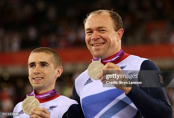 Silver medallists Neil Fachie and Barney Storey of Great Britain pose on the podium during the medal ceremony for the Men's Individual Cycling B...