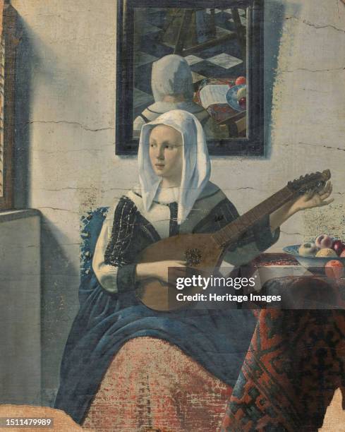 Woman playing a cittern, 1930-1940. Seated woman reflected in the mirror on the wall behind her. Painted in the style of Johannes Vermeer. Henricus...