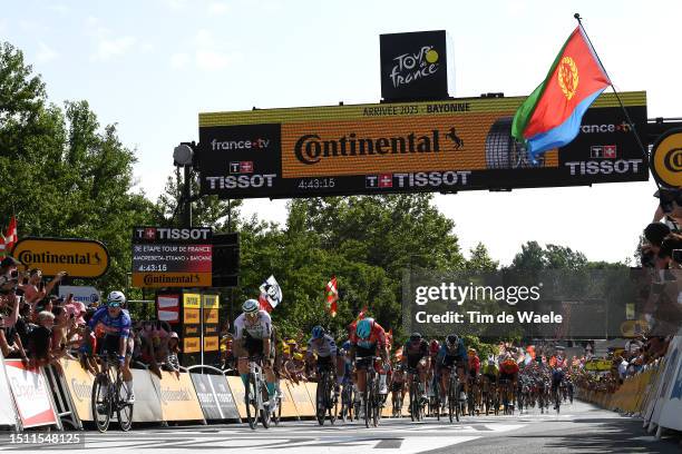 General view of Jasper Philipsen of Belgium and Team Alpecin-Deceuninck celebrates at finish line as stage winner ahead of Wout Van Aert of Belgium...