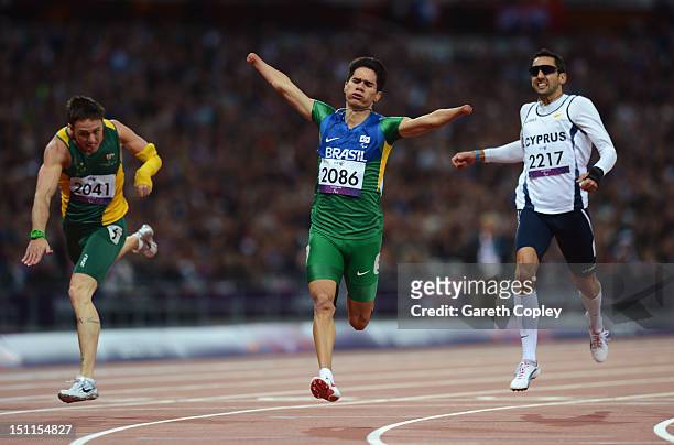 Yohansson Nascimento of Brazil crosses the line ahead of Simon Patmore of Australia and Antonis Aresti of Cyprus in the Men's 200m - T46 Final to win...