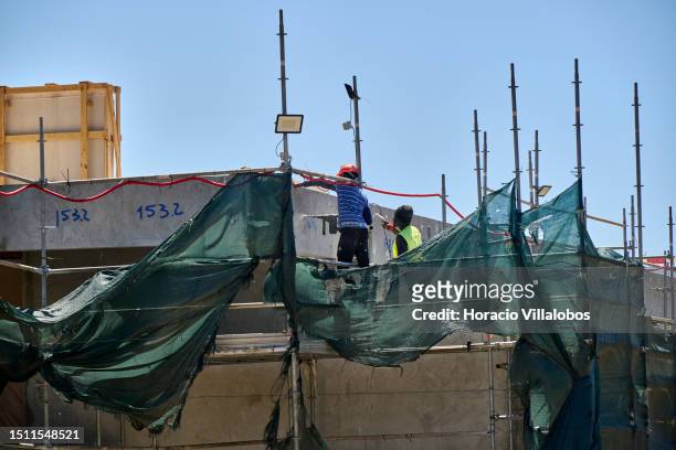 Construction workers are seen at Cristiano Ronaldo's mansion under construction near the Oitavos Dunes Golf Course clubhouse in Quinta da Marinha on...