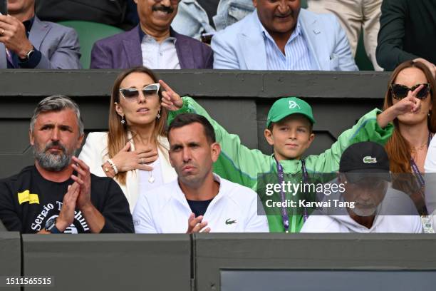 Goran Ivanišević, Jelena Djokovic and Stefan Djokovic watching Pedro Cachín V Novak Djokovic on day one of the Wimbledon Tennis Championships at the...