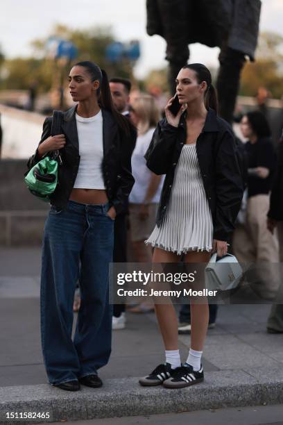 Vittoria Ceretti is seen wearing black oversized jacket, ruffled white dress, turquoise Alaia Le Papa bag and black Adidas Gazelle sneakers outside...