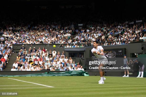 Novak Djokovic of Serbia in action against Pedro Cachin of Argentina in the Gentlemen's Singles first round match on Centre Court during the...