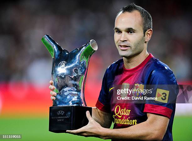 Andres Iniesta of FC Barcelona poses with the UEFA Best Player in Europe 2012 trophy prior to the La Liga match between FC Barcelona and Valencia CF...