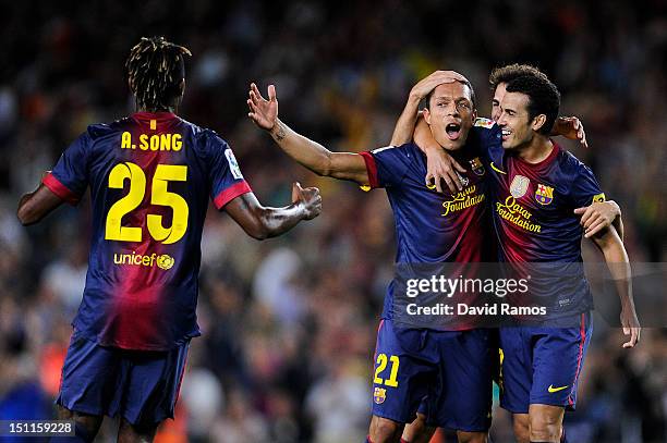Adriano Correia of FC Barcelona celebrates with team-mate Pedro Rodriguez after scoring the opening goal during the La Liga match between FC...