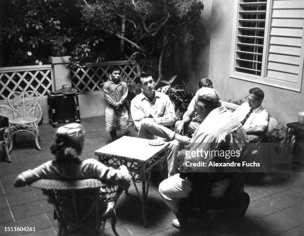 Actors Rock Hudson, Burl Ives and Ibrahim Pendek, actress Gena Rowland and Director Robert Mulligan chatting in the evening after a day of filming...