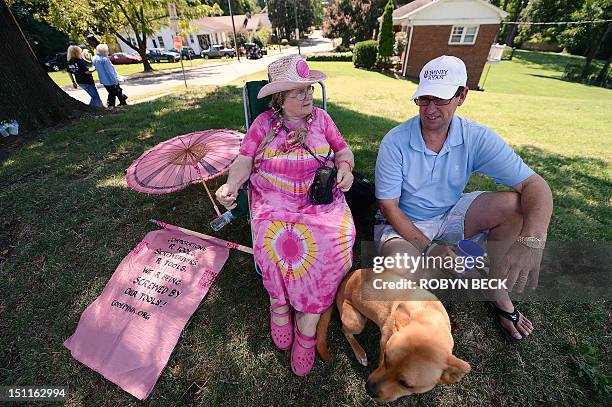 Elizabeth Barger , a Code Pink supporter from Tennesse, stops to talk politics with Mitt Romney supporter Andy Dulin of Charlotte, North Carolina,...