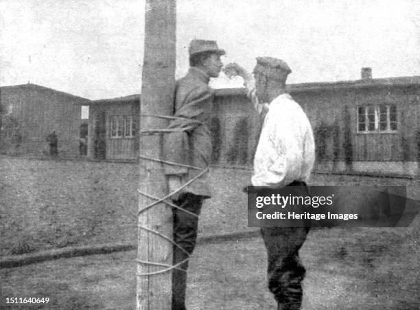 'La peine du poteau; a Zwickau: un Francais, lie au poteau, recoit d'un prisonnier roumain son compagnon de misere, l'aumone d'un verre d'eau', 1917....