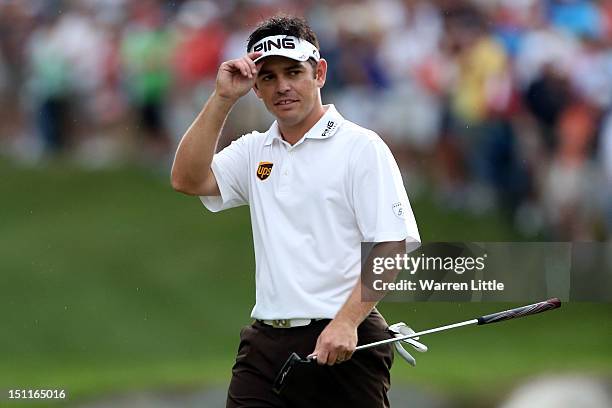 Louis Oosthuizen of South Africa tips his cap as he walks up the 18th green during the third round of the Deutsche Bank Championship at TPC Boston on...