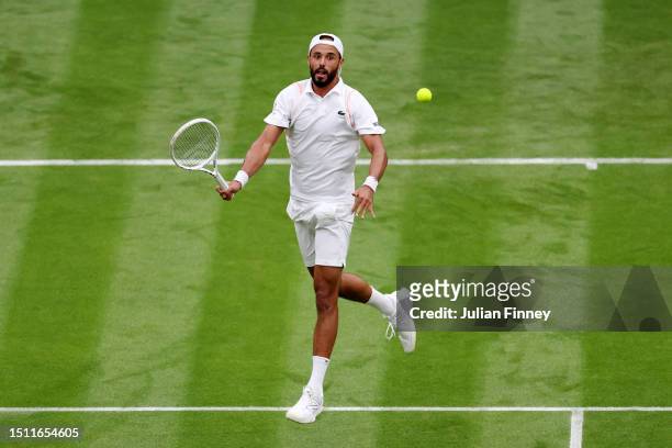 Laurent Lokoli of France plays a forehand against Casper Ruud of Norway in the Men's Singles first round match on day one of The Championships...