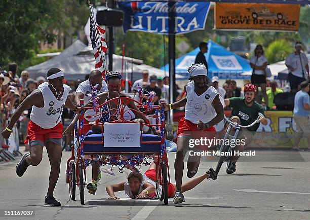 Team "Racing for Obama" loses a member as they participate in the first heat of the Coconut Grove Bed Race. Five-member teams in costume raced...