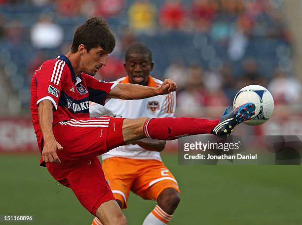 Alvaro Fernandez of the Chicago Fire kicks the ball away from Boniek Garcia of the Houston Dynamo during an MLS match at Toyota Park on September 2,...