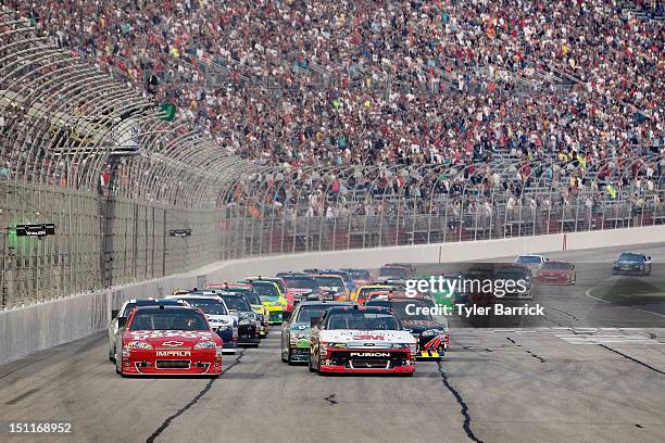 Tony Stewart, driver of the Office Depot/Mobil 1 Chevrolet and Greg Biffle, driver of the 3M/Manheim Auctions Ford, lead the field at the start of...