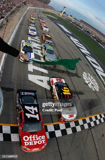 Tony Stewart, driver of the Office Depot/Mobil 1 Chevrolet and Greg Biffle, driver of the 3M/Manheim Auctions Ford, lead the field at the start of...