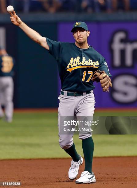 Infielder Adam Rosales of the Oakland Athletics throws the ball against the Tampa Bay Rays during the game at Tropicana Field on August 24, 2012 in...