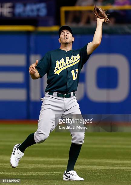 Infielder Adam Rosales of the Oakland Athletics catches a fly ball against the Tampa Bay Rays during the game at Tropicana Field on August 24, 2012...