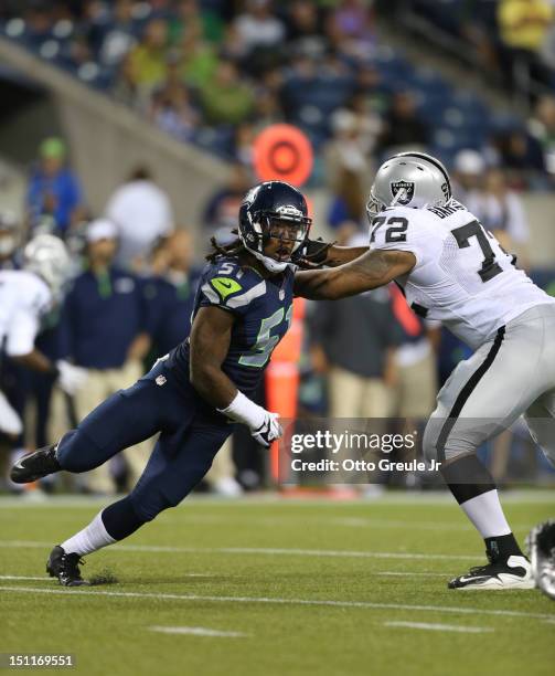 Defensive end Bruce Irvin of the Seattle Seahawks battles Joe Barksdale of the Oakland Raiders at CenturyLink Field on August 30, 2012 in Seattle,...