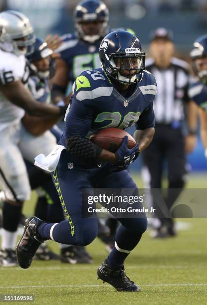 Running back Kregg Lumpkin of the Seattle Seahawks rushes against the Oakland Raiders at CenturyLink Field on August 30, 2012 in Seattle, Washington.