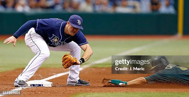 Infielder Evan Longoria of the Tampa Bay Rays applies the tag to Coco Crisp of the Oakland Athletics as he tried to steal third during the game at...