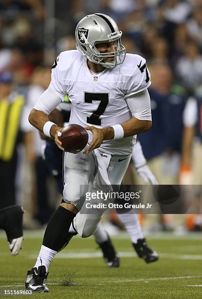Quarterback Matt Leinart of the Oakland Raiders looks to hand off against the Seattle Seahawks at CenturyLink Field on August 30, 2012 in Seattle,...